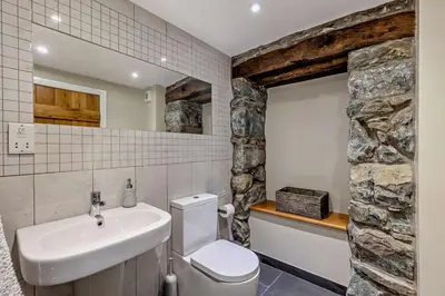 a bathroom with a white toilet and a sink at 3 Bed in Dyffryn Ardudwy oc-f29350 in Dyffryn