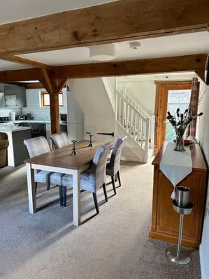 a kitchen and dining room with a table and chairs at Serafina Cottage in Leominster
