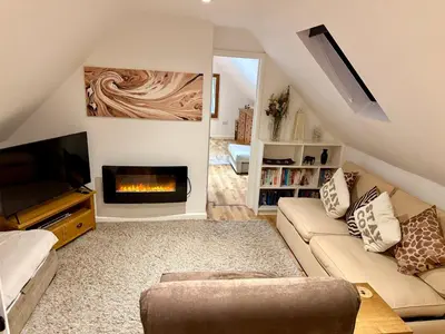 a living room with a couch and a fireplace at Serafina Lodge in Leominster