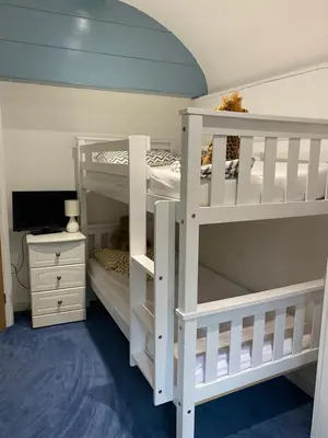 two white bunk beds in a room at The chapel in Machynlleth