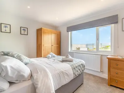 a bedroom with a bed and a window and a dresser at Goppa in Llanfair
