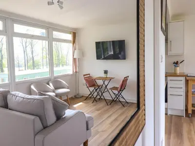 a living room with a couch and a table at Hill View in Tywyn