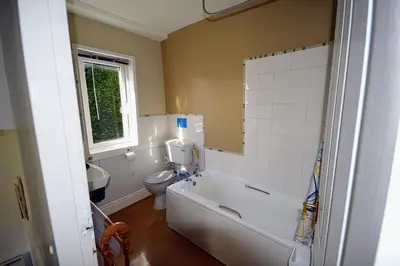 a bathroom with a toilet and a tub and a sink at Swn y nant Barmouth road A496 Llanelltyd in Penmaenpool
