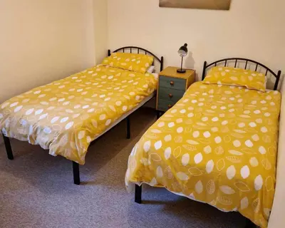 two beds sitting next to each other in a room at Swn y nant Barmouth road A496 Llanelltyd in Penmaenpool
