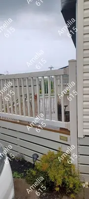 a porch with a white railing on a house at Amelia 615 Barmouth in Talybont