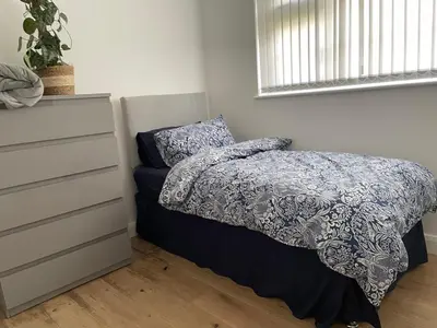a bedroom with a bed and a dresser at Birch Villa in Aberystwyth