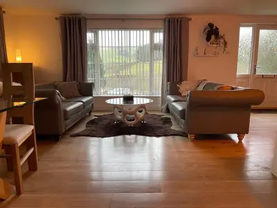 a living room with a couch and a table at Birch Villa in Aberystwyth