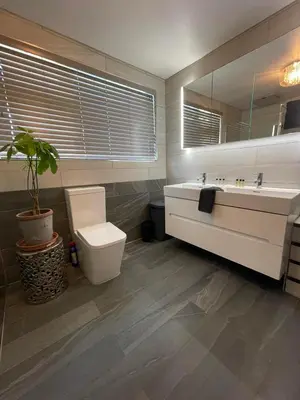 a bathroom with a sink and a toilet and a mirror at Birch Villa in Aberystwyth