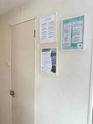 a wall with two posters on a wall with a door at MoonStone in Aberystwyth