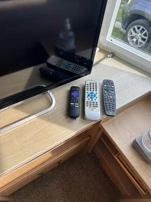 three remote controls sitting on top of a desk at MoonStone in Aberystwyth