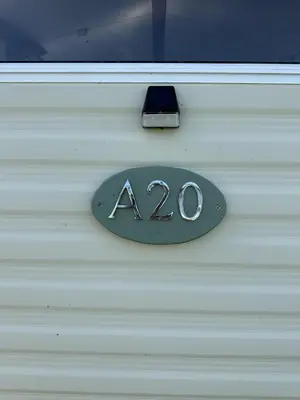 a sign on a white door with on it at MoonStone in Aberystwyth