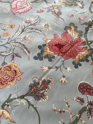 a pattern of flowers on a blue blanket at Stylish Shepherds Hut with Amazing Views in Knighton