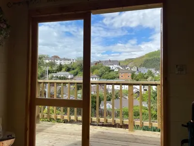 a view from a window of a balcony at Stylish Shepherds Hut with Amazing Views in Knighton