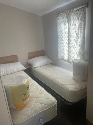 a room with two beds and a window at Caravan by the beach in Borth