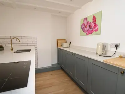 a kitchen with gray cabinets and a counter top at Osborne House in Rhayader