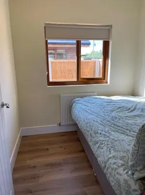 a bedroom with a bed and a window at Weston pools Lodge with 6 Bedrooms in Oswestry