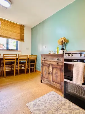 a living room with a stove and a dining room at The Guest House near Hay on Wye in Hereford