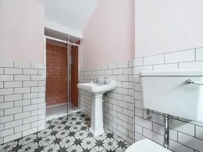 a white bathroom with a sink and a toilet at Plas Amherst in Harlech