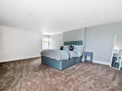 a bedroom with a bed in a white room at Valerian Lodge in Harlech
