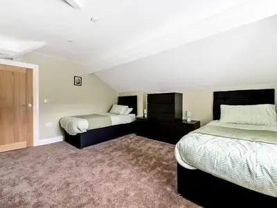 two beds in a room with two beds sidx sidx sidx at Valerian Lodge in Harlech