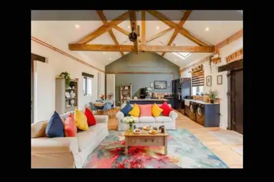 a living room with a couch and a table at Tank Barn at Brook House, Nestled in the Welsh Hills, a delightful retreat in Welshpool