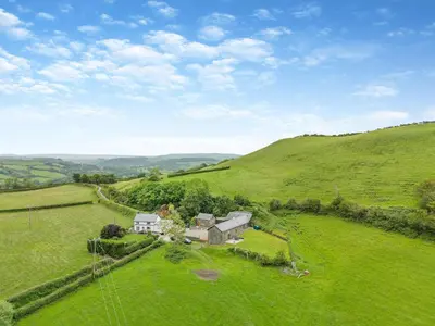 an aerial view of a house in a green field at Ty Carreg in Llanbadarn-fawr