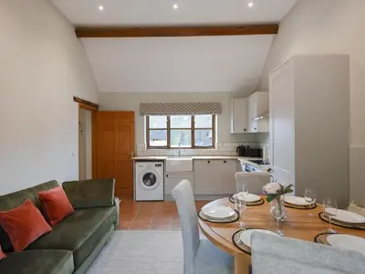 a kitchen and living room with a table and a couch at Uk46557 - Caradoc in Church Stretton