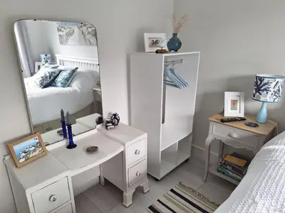 a bedroom with a dressing table and a mirror at Brynarfor near Aberaeron in Llanon