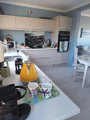 a kitchen with two cups and a tea kettle on a counter at Brynarfor near Aberaeron in Llanon