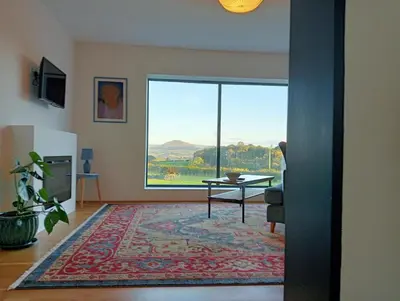 a living room with a large window and a table at The Slow House Apartments, Llandefalle in Brecon