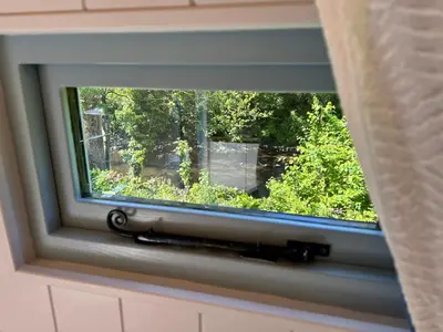a window with a view of a garden at Cwt Bugail Aeron in Aberaeron