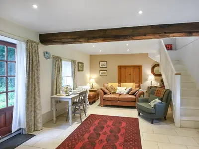 a living room with a couch and a table at Home Farm Barn in Pontesbury