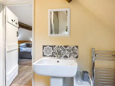 a bathroom with a sink and a mirror at Home Farm Barn in Pontesbury
