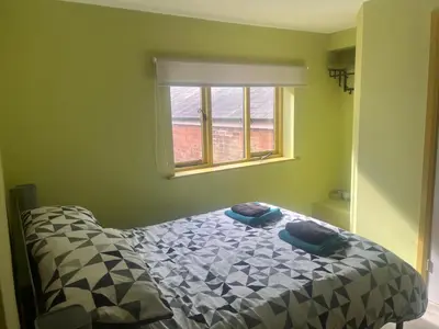a bedroom with a bed and a window at Tumbledown Hotel in Shrewsbury