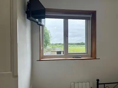 a window in a room with a view of a field at Kimberly House in Arthog