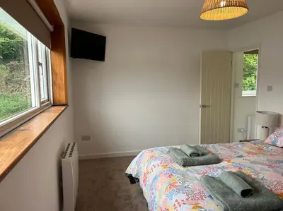 a bedroom with a bed and a window at Kimberly House in Arthog