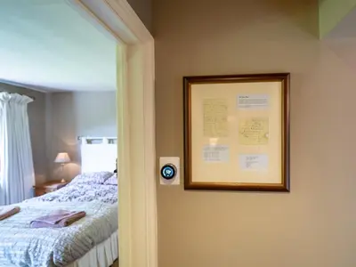 a picture hanging on a wall next to a bed at The Old Chapel Charming countryside retreat - Pass the Keys in Ludlow