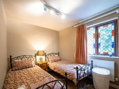 two beds in a room with a window at The Old Chapel Charming countryside retreat - Pass the Keys in Ludlow