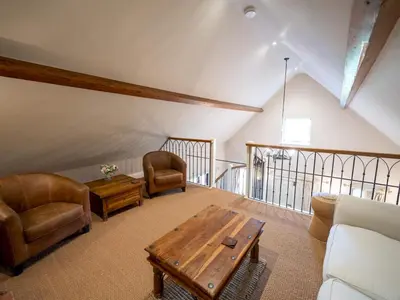 a living room with a couch and a table and chairs at The Old Chapel Charming countryside retreat - Pass the Keys in Ludlow