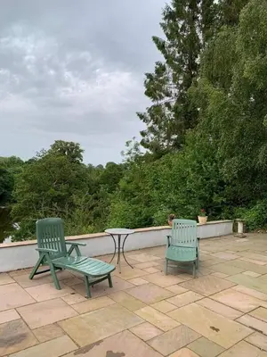 two green chairs and a table on a patio at Trevonnen in Llyswen