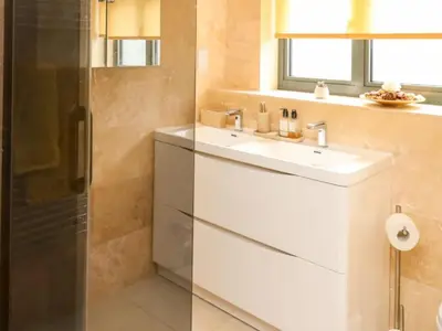 a bathroom with a white sink and a shower at Trevonnen in Llyswen