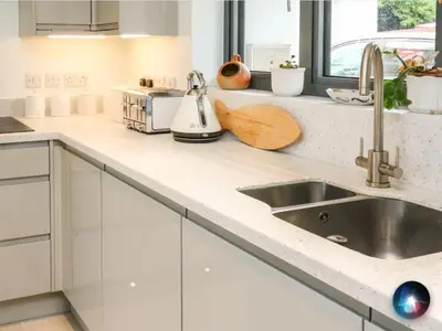 a kitchen with white cabinets and a sink at Trevonnen in Llyswen