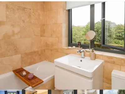 a bathroom with a sink and a tub and a mirror at Trevonnen in Llyswen