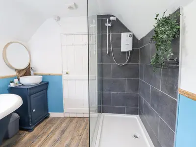a bathroom with a shower and a sink at Ivy Cottage in Harlech