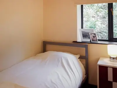 a small bedroom with a bed and a window at Oak View Cottage in Llangunllo