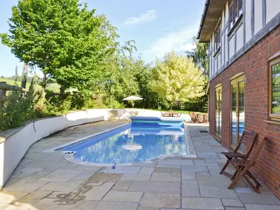 a swimming pool in the backyard of a house at Celyn in Montgomery