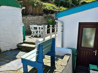 a blue bench sitting next to a building at The Rope and Anchor Aberaeron in Aberaeron