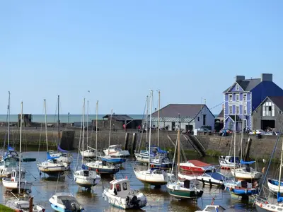 a bunch of boats are docked in the water at The Rope and Anchor Aberaeron in Aberaeron