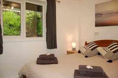 a bedroom with two towels on a bed with a window at No 6 at Dolgoch Falls Cottages in Bryn-crug