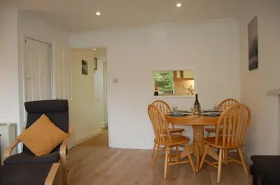 a kitchen and dining room with a table and chairs at No 6 at Dolgoch Falls Cottages in Bryn-crug